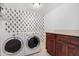 Laundry room with washer, dryer, and cactus print wall at 1710 E 1St St, Mesa, AZ 85203