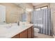 Bathroom with double sinks, shower, and linen closet at 18147 W Desert View Ln, Goodyear, AZ 85338