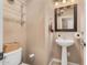 Clean and well-lit bathroom with pedestal sink and glass shelving at 18147 W Desert View Ln, Goodyear, AZ 85338