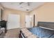 Bedroom with a queen-size bed and double doors leading to the bathroom at 18147 W Desert View Ln, Goodyear, AZ 85338