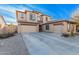 Two-story house with three-car garage, desert landscaping, and light-colored exterior at 18147 W Desert View Ln, Goodyear, AZ 85338