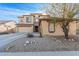 Two-story house with desert landscaping, two-car garage, and neutral color palette at 18147 W Desert View Ln, Goodyear, AZ 85338