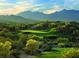 Scenic golf course view with lush greenery, sand traps, and mountain backdrop for a luxurious lifestyle at 18147 W Desert View Ln, Goodyear, AZ 85338