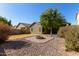 Landscaped backyard with fire pit and gravel at 18239 N Cook Dr, Maricopa, AZ 85138