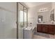 Clean bathroom with a soaking tub, shower, and dark wood vanity at 18239 N Cook Dr, Maricopa, AZ 85138