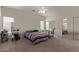 Well-lit bedroom with striped bedding and mirrored closet doors at 18239 N Cook Dr, Maricopa, AZ 85138