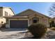 One-story house with brown garage door and landscaped front yard at 18239 N Cook Dr, Maricopa, AZ 85138