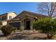 One-story house with brown garage door and landscaped front yard at 18239 N Cook Dr, Maricopa, AZ 85138