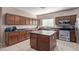 Modern kitchen featuring a center island and dark wood cabinetry at 18239 N Cook Dr, Maricopa, AZ 85138