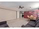 Spacious living room with tile floors and baseball memorabilia at 18239 N Cook Dr, Maricopa, AZ 85138