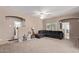 Living room with sectional sofa and access to bathroom at 18239 N Cook Dr, Maricopa, AZ 85138