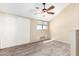 Bright bedroom with ceiling fan, carpet, and sliding door at 19820 N 13Th Ave # 267, Phoenix, AZ 85027