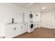 Laundry room with stackable washer/dryer and white cabinets at 2024 E Whitton Ave, Phoenix, AZ 85016