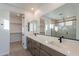 Modern bathroom with double vanity, large mirror, and walk-in shower at 21259 E Sparrow Dr, Queen Creek, AZ 85142