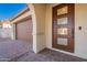 Contemporary front door with glass panels and arched entryway at 21259 E Sparrow Dr, Queen Creek, AZ 85142