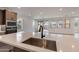 Kitchen island with sink, stainless steel sink, and white quartz countertop at 21259 E Sparrow Dr, Queen Creek, AZ 85142