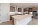 Modern kitchen with quartz countertops and dark wood cabinets at 21259 E Sparrow Dr, Queen Creek, AZ 85142