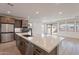 Open kitchen with island, stainless steel appliances, and backyard access at 21259 E Sparrow Dr, Queen Creek, AZ 85142