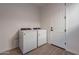 Bright laundry room, featuring washer, dryer, and ample space at 21259 E Sparrow Dr, Queen Creek, AZ 85142