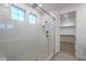 Modern bathroom with glass shower and closet access at 21290 E Sparrow Dr, Queen Creek, AZ 85142