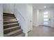 Carpeted staircase with modern lighting and neutral walls at 21290 E Sparrow Dr, Queen Creek, AZ 85142