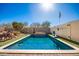 Relaxing rectangular pool in a sunny backyard setting with a basketball hoop at 25543 W St Kateri Dr, Buckeye, AZ 85326