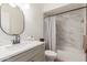 Modern bathroom with marble tile, updated vanity, and bathtub at 2664 W Ocaso Cir, Mesa, AZ 85202