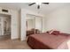 Bedroom with mirrored closet doors and striped bedding at 2664 W Ocaso Cir, Mesa, AZ 85202