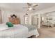 Bright bedroom with mirrored closet doors and ceiling fan at 2664 W Ocaso Cir, Mesa, AZ 85202