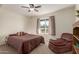 Cozy bedroom with a leopard print chair and large window at 2664 W Ocaso Cir, Mesa, AZ 85202
