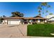 Ranch style home with a two-car garage and well-manicured lawn at 2664 W Ocaso Cir, Mesa, AZ 85202