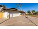 White house with a two-car garage and gravel driveway at 2664 W Ocaso Cir, Mesa, AZ 85202