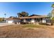 Single story home with a spacious lawn and mature trees at 2664 W Ocaso Cir, Mesa, AZ 85202