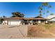 Ranch style home with a two-car garage and landscaped yard at 2664 W Ocaso Cir, Mesa, AZ 85202