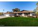 Single story home with a spacious lawn and mature trees at 2664 W Ocaso Cir, Mesa, AZ 85202