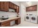 Laundry room with washer, dryer, and built-in cabinets at 2664 W Ocaso Cir, Mesa, AZ 85202
