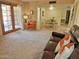 Open-concept living room featuring a dining area, large windows, and comfortable seating arrangements at 2664 W Ocaso Cir, Mesa, AZ 85202