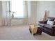 Bright living room with large window, comfortable seating, and stylish decorative accents at 2664 W Ocaso Cir, Mesa, AZ 85202