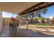 Covered patio with table and chairs, overlooking backyard at 2664 W Ocaso Cir, Mesa, AZ 85202