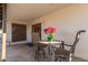 Small patio with table and chairs, adjacent to house at 2664 W Ocaso Cir, Mesa, AZ 85202