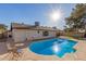 Stunning kidney-shaped pool with patio seating at 2664 W Ocaso Cir, Mesa, AZ 85202