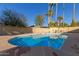 Sparkling blue pool with a large patio area, surrounded by a block wall at 2664 W Ocaso Cir, Mesa, AZ 85202