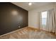 Bedroom with dark accent wall and ceiling fan at 2759 E Mews Rd, Gilbert, AZ 85298