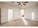 Bright bedroom with carpet, ceiling fan, and bathroom access at 2759 E Mews Rd, Gilbert, AZ 85298