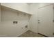 Laundry room with built-in shelving and door at 2759 E Mews Rd, Gilbert, AZ 85298