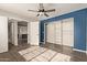 Bedroom with wood floors, ceiling fan, and built-in shelving at 4901 S Calle Los Cerros Dr # 241, Tempe, AZ 85282