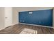 Simple bedroom with dark wood floors and blue accent wall at 4901 S Calle Los Cerros Dr # 241, Tempe, AZ 85282