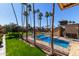 Community pool with lush landscaping and palm trees at 4901 S Calle Los Cerros Dr # 241, Tempe, AZ 85282