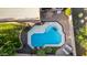 Aerial view of a refreshing blue pool, surrounded by a patio and lush landscaping at 4939 W Jomax Rd, Phoenix, AZ 85083