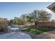 Artificial turf backyard with patio seating and large tree at 5037 E Sleepy Ranch Rd, Cave Creek, AZ 85331